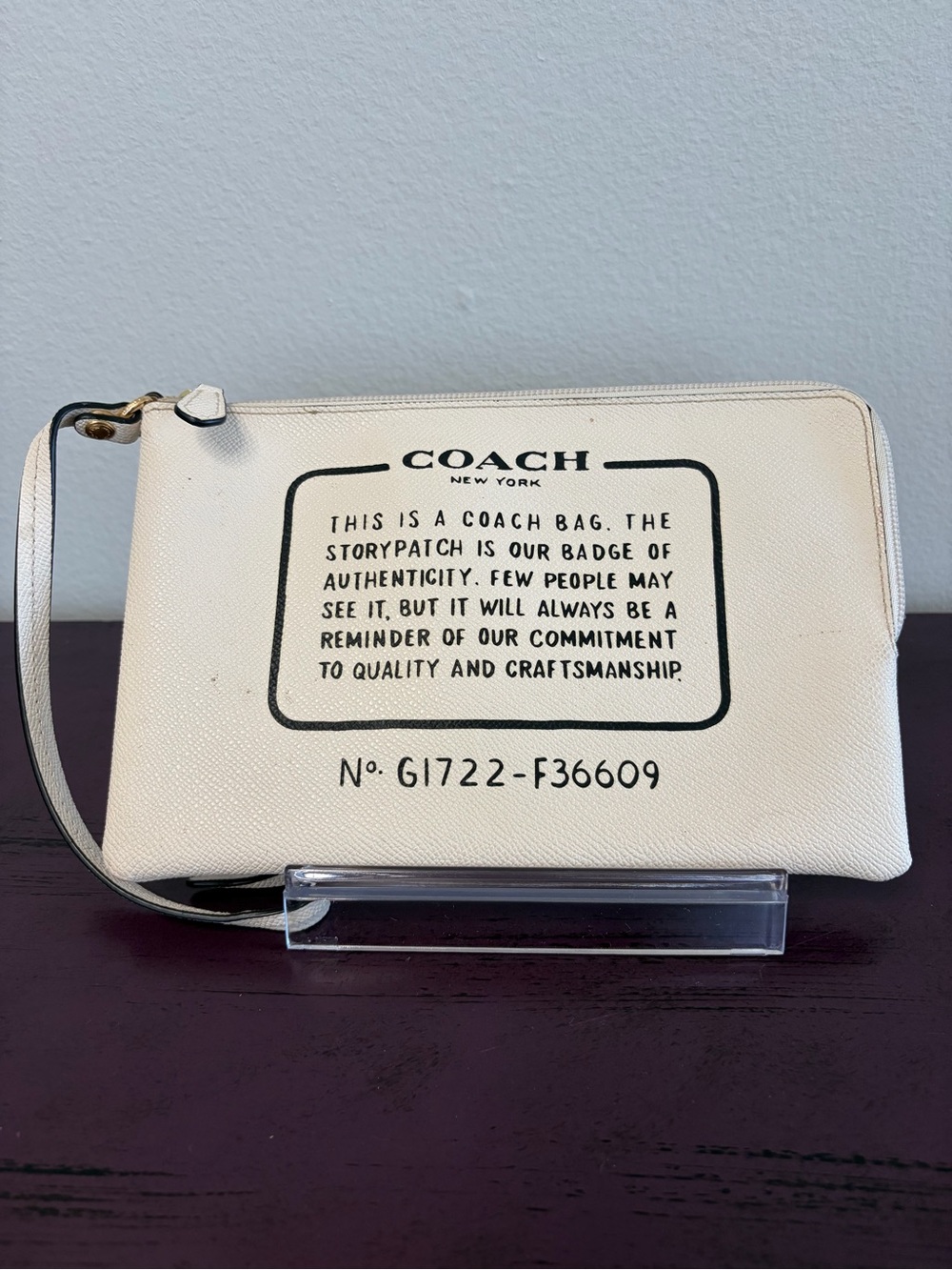 COACH Cream Storypatch Wristlet with Black Lettering